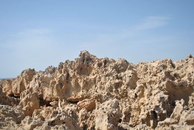 Low angle view of rock formations against sky