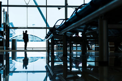 Silhouette man standing at airport