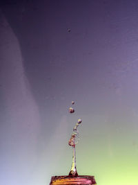 Low angle view of statue by building against sky