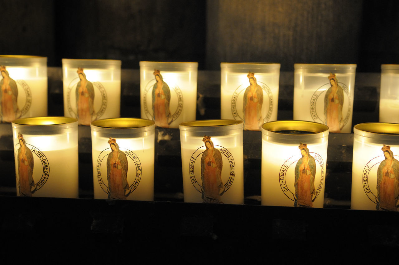 CLOSE-UP OF ILLUMINATED CANDLES IN GLASS SHOP