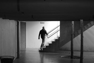 Full length of woman standing on railing