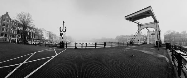 Empty road against sky in city