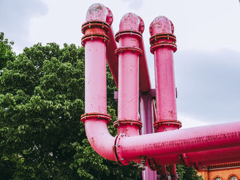 Low angle view of pipes against sky