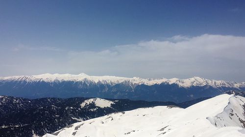 Scenic view of snowcapped mountains against sky