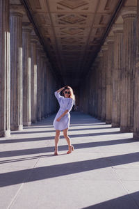 Portrait of woman standing at colonnade
