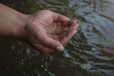 Close-up of hand holding water