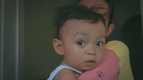 Close-up portrait of cute baby girl at home