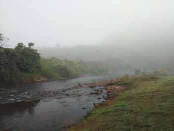 Scenic view of landscape against sky during foggy weather