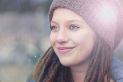 Close-up portrait of smiling young woman