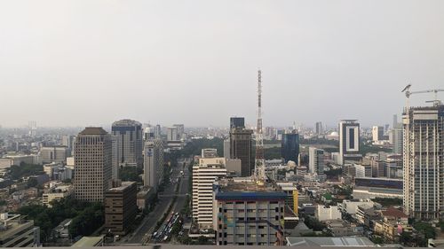 Modern buildings in city against clear sky