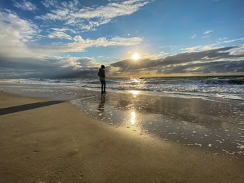 Man on beach against sky