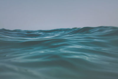Close-up of rippled water in swimming pool against clear sky