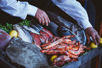 Midsection of man preparing food