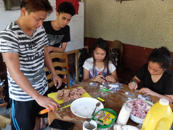 High angle view of siblings sitting on table