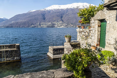 The village of corenno plinio with stone houses overlooking a small port