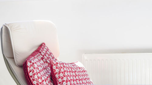 Midsection of man reading book on sofa at home