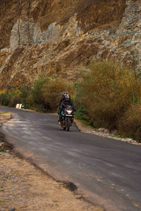 Car riding motorcycle on road