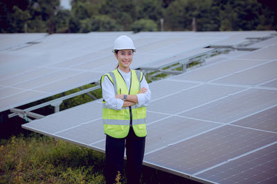 Portrait of young man standing against solar panel