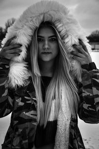Portrait of young woman wearing hooded jacket