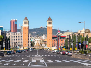 City street and buildings against clear sky