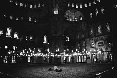 Man in illuminated building at night