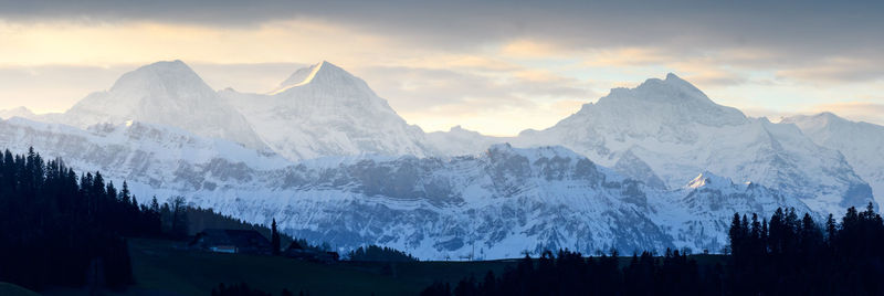 Panoramic view of snowcapped mountains against sky during sunset
