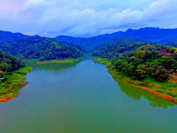 Scenic view of lake and mountains against sky