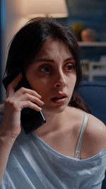 Portrait of young woman using mobile phone