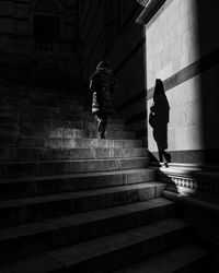 Rear view of man walking on staircase