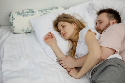 Woman sleeping on bed at home