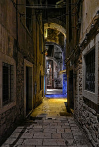 Empty alley amidst buildings