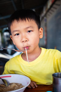 Portrait of boy eating food