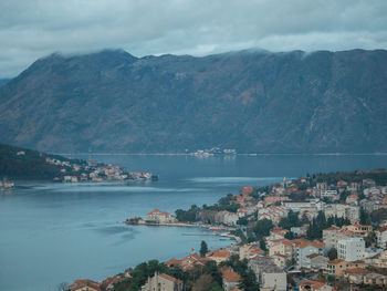 High angle view of sea and mountains against sky