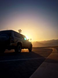 Sun shining through car on road