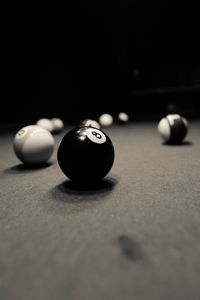 Close-up of snooker balls on table against black background