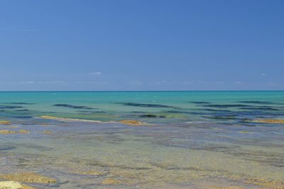 Scenic view of sea against clear blue sky