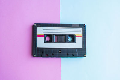 Directly above shot of audio cassette on colored background