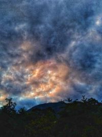 Low angle view of silhouette mountain against sky at sunset