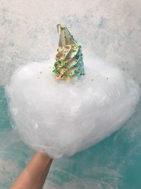 Low section of person with christmas tree in snow