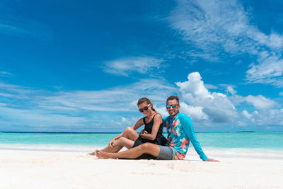 Young couple sitting on beach