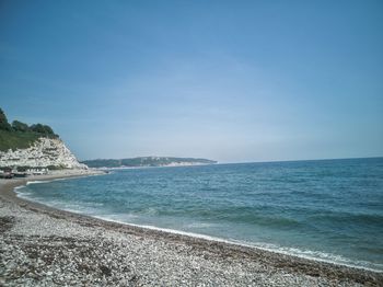 Scenic view of sea against blue sky