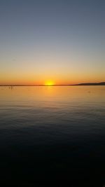 Scenic view of sea against clear sky at sunset