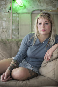 Portrait of young woman sitting outdoors