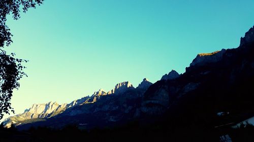 Scenic view of mountains against clear blue sky