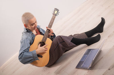 Full length of man playing guitar