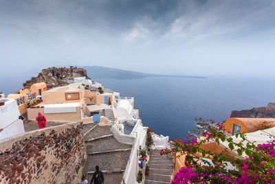 High angle view of buildings by sea against sky