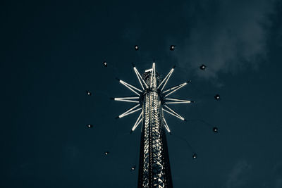 Low angle view of illuminated ferris wheel against sky at night