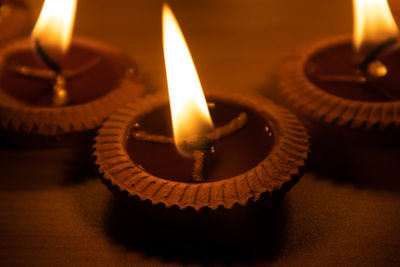 Close-up of illuminated tea light candles on table