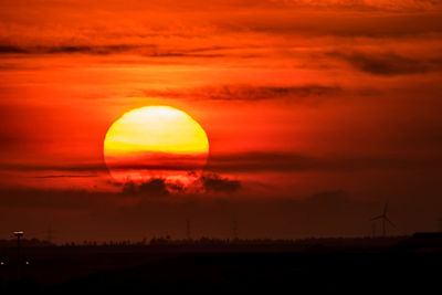 Scenic view of sunset over silhouette landscape