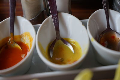 High angle view of  bowls with  sauce on table